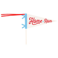 Isolated cream felt pennant with red “Home Run” script, blue trim, red ribbon tails, and attached wooden dowel on a white backdrop.