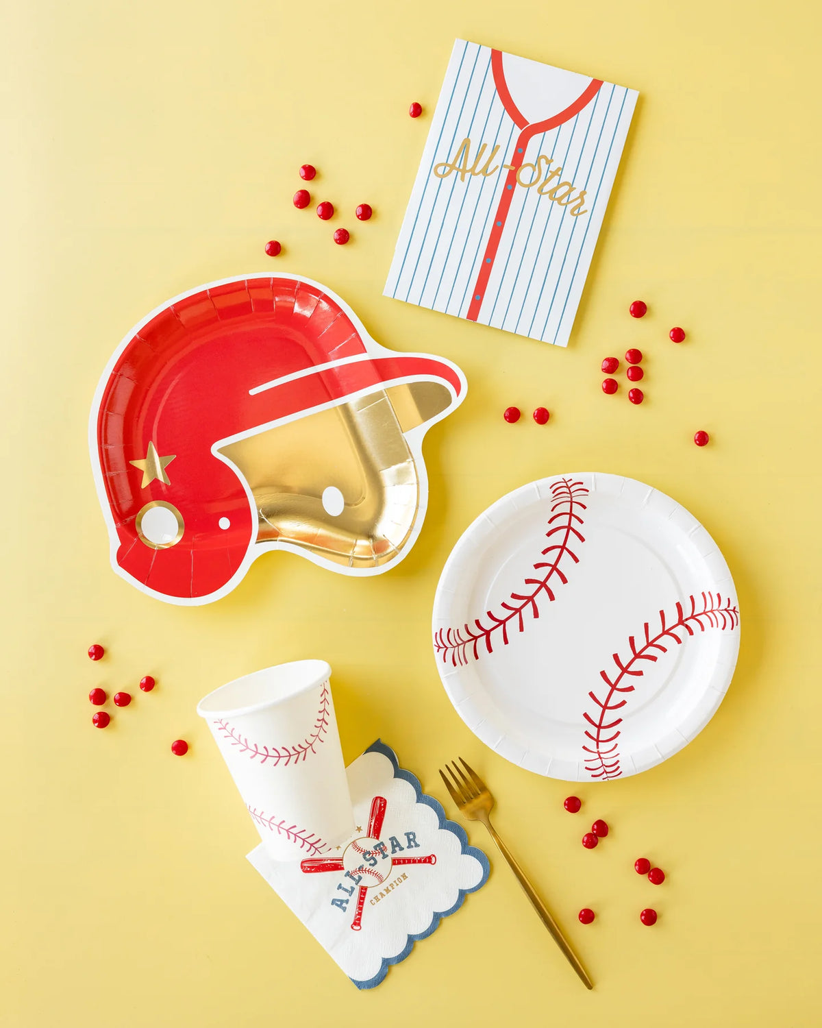 Baseball party place setting on yellow background with helmet‑shaped plate, stitched cup, baseball plate, and “All‑Star” napkin.
