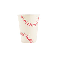 Close‑up of single ivory cup displaying two red curved baseball seams.