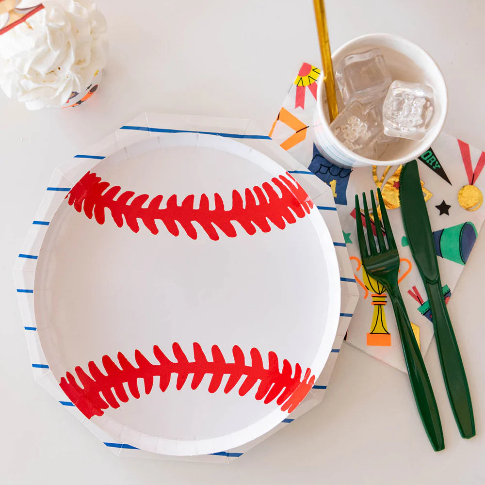 A close-up view of a baseball paper plate styled with playful party napkins, striped cups, and green utensils—perfect for a sporty birthday or team celebration.