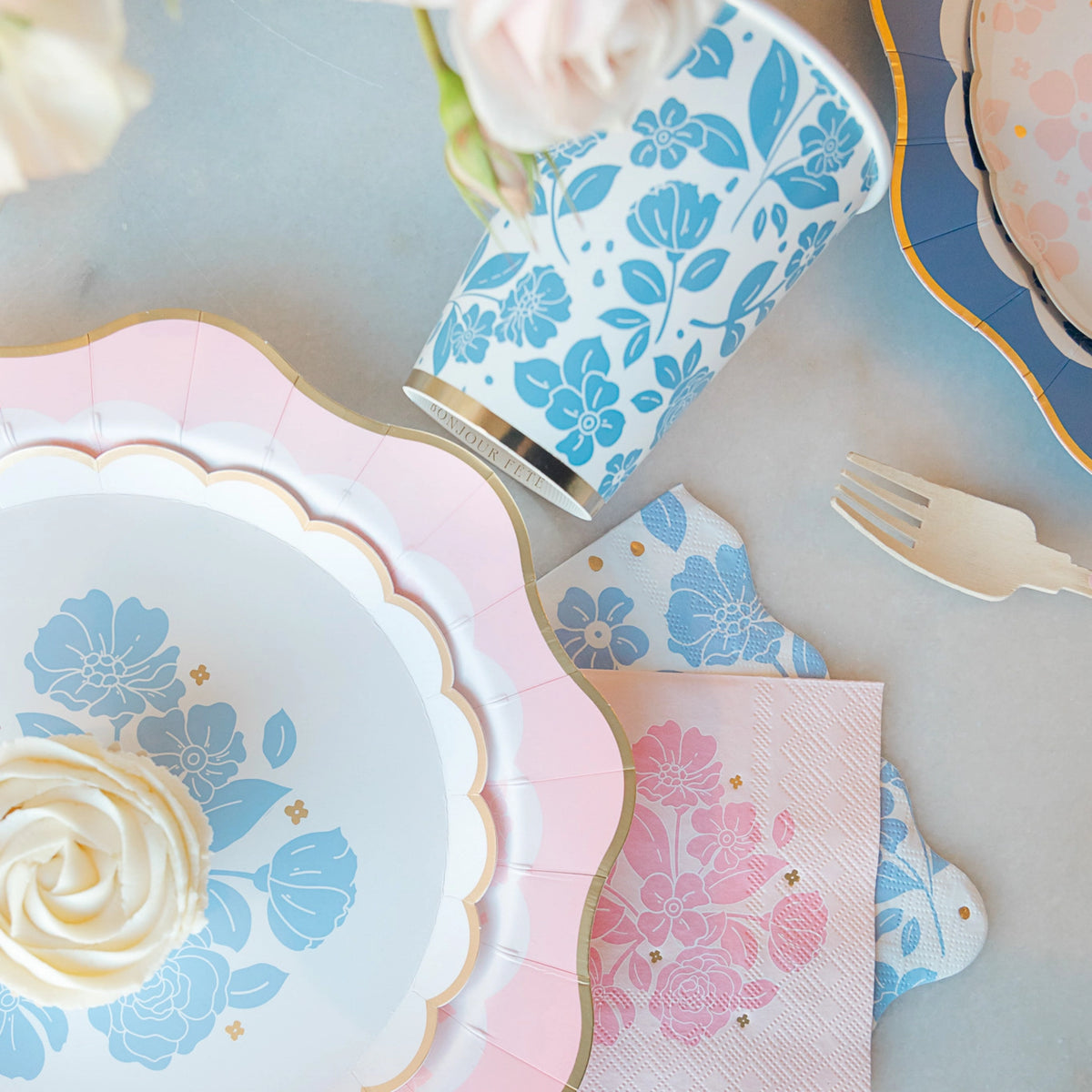 Close-up place setting with Belle Blue dessert plate, matching cup, and floral napkins—periwinkle blue floral plates.