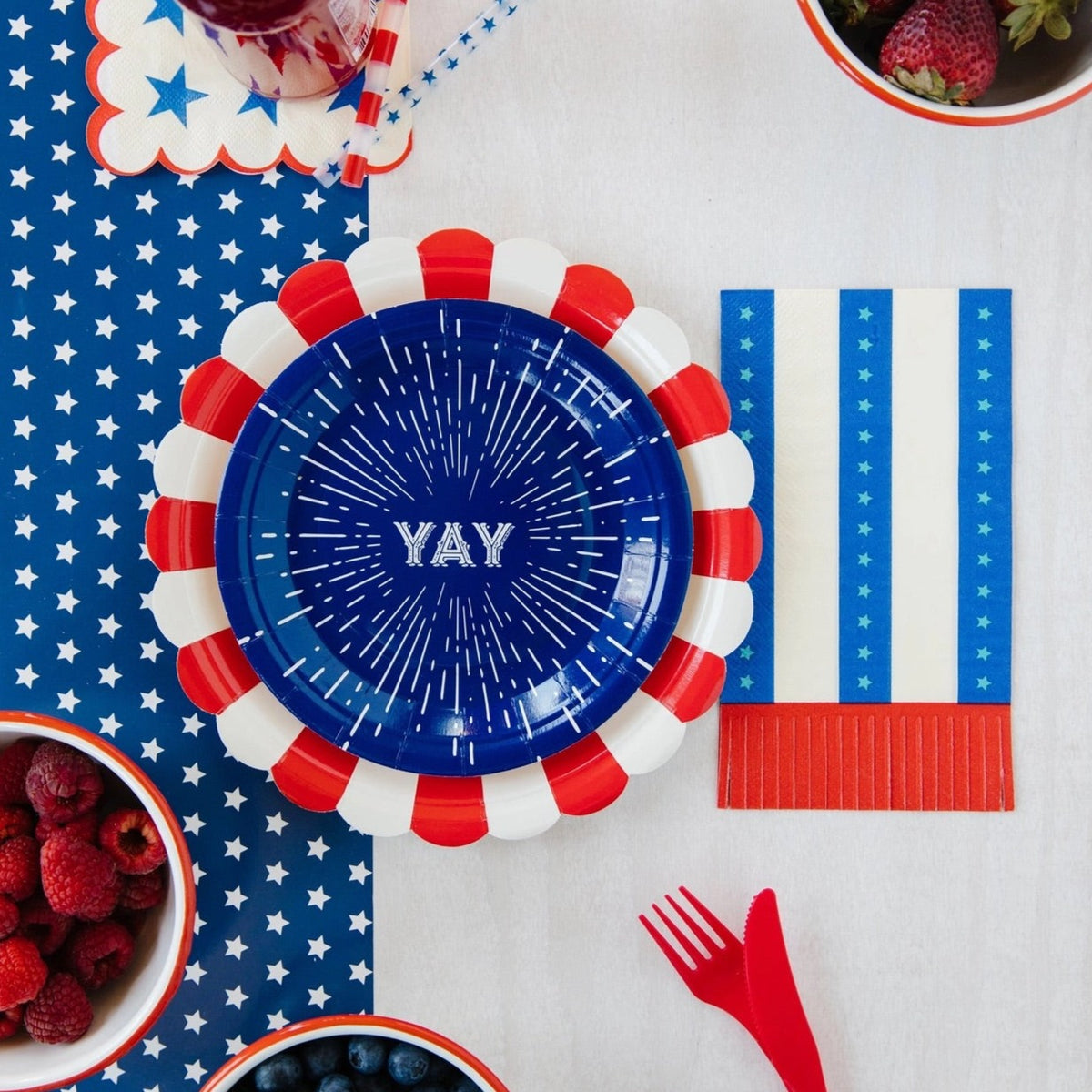 Blue paper dessert plates with a firework design and the word yay in the center - perfect for a 4th of july party or 1st birthday party.