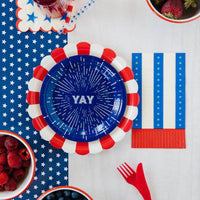 Blue paper dessert plates with a firework design and the word yay in the center - perfect for a 4th of july party or 1st birthday party.