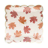 Front view of falling-leaves print paper plates with gold-foil scalloped border.