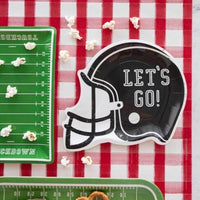 Football party table featuring football helmet shaped paper plates