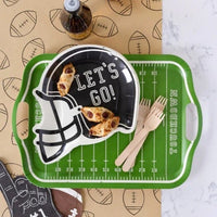 Football party table featuring football helmet shaped paper plates