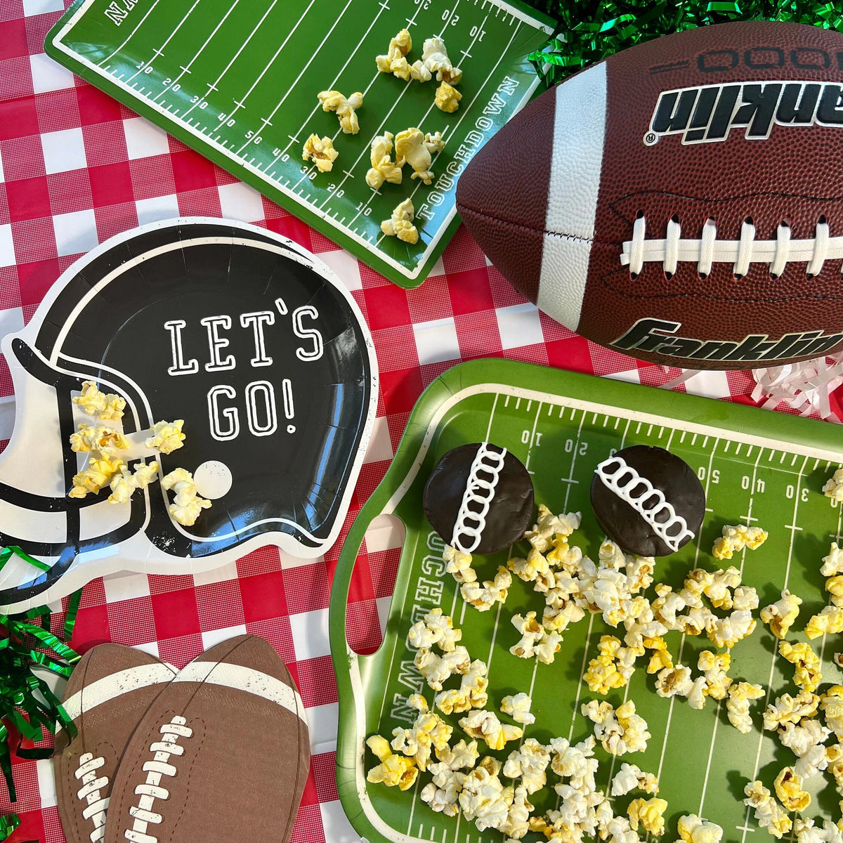 Football party table featuring football helmet shaped paper plates