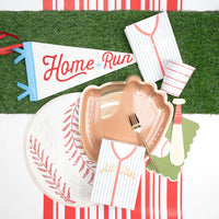 Baseball placemat styled with a glove shaped plate, jersey napkins, and a Home Run pennant.