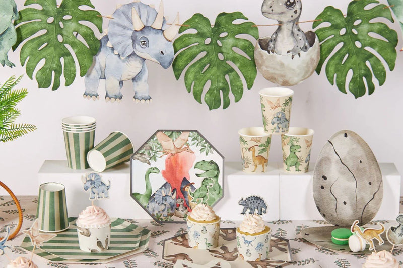 dinosaur birthday party table with themed plates cups napkins and decorations