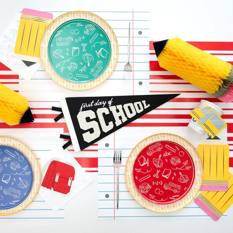 Back to school breakfast table setup with school-themed plates, cups, and decorations for kids