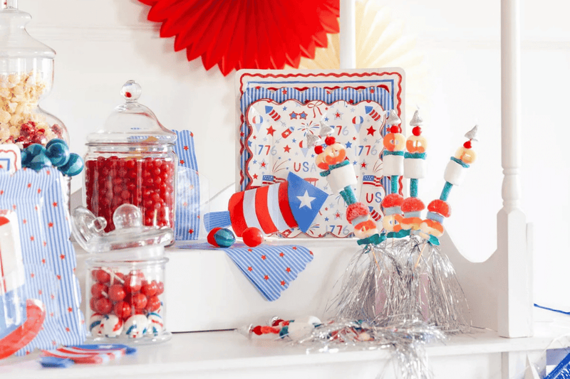 Fourth of July table spread, featuring firecracker-themed party plates and napkins.