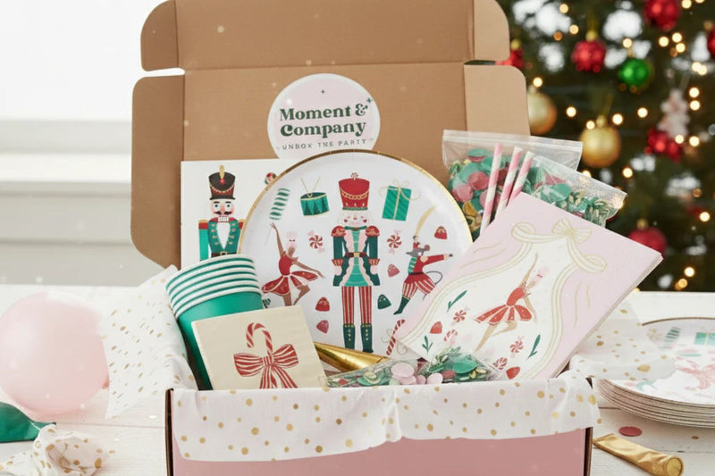 Holiday subscription box filled with coordinated party supplies, decorations, and themed tableware