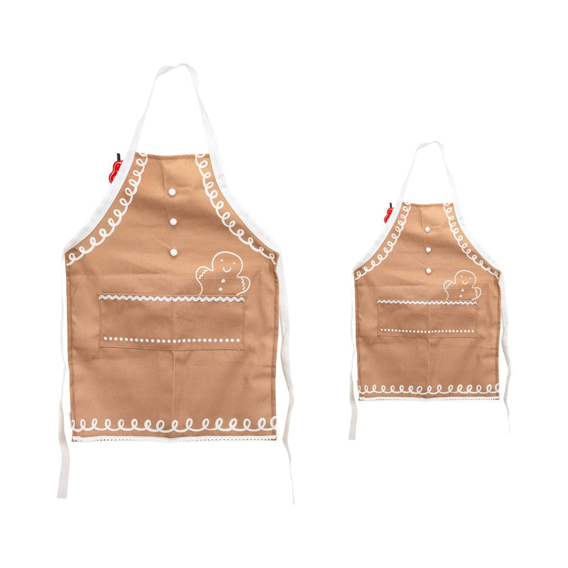 Adult and youth Gingerbread Aprons displayed side by side, showing matching designs with white icing trim and front pockets.