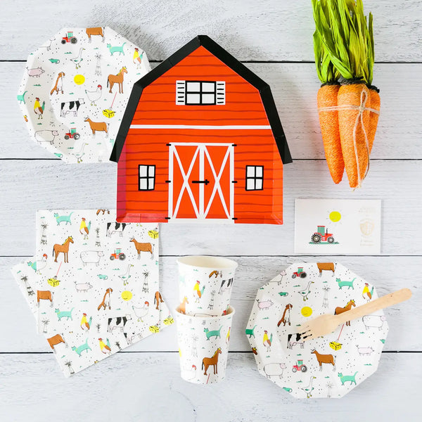 Flat lay of barn plate with matching farm animal tableware and faux carrot décor.