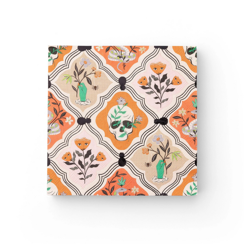 Flat-lay of unfolded Halloween dinner napkin with skull, spiders, and floral gothic motifs.