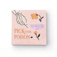 Flat lay of pink cocktail napkin featuring skeleton hand, purple coupe glass, florals, spider, and “Pick Your Poison” text.