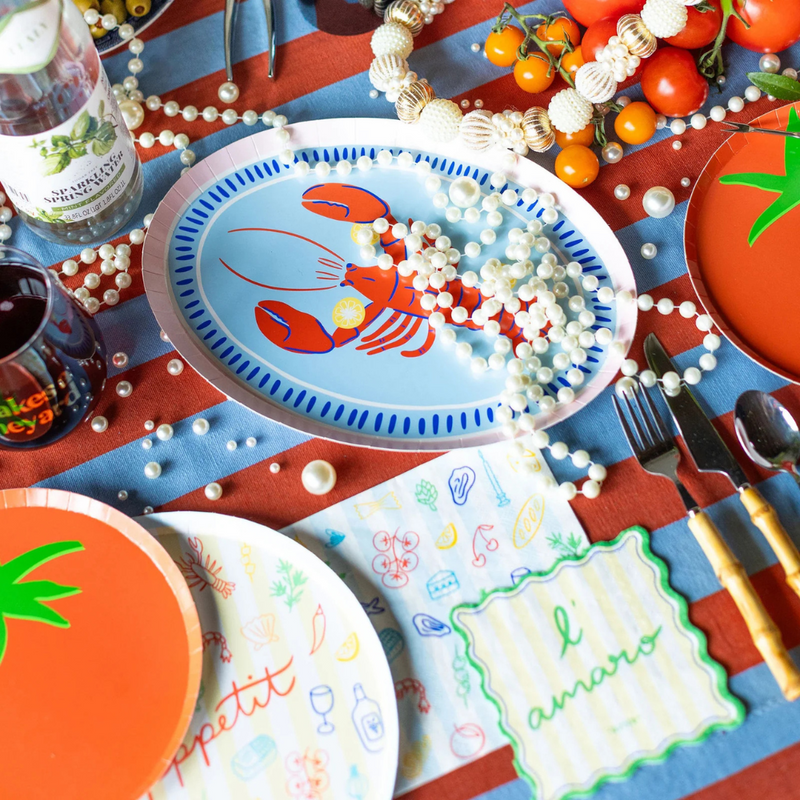 Le Dinner Large Napkin featuring colorful food illustrations on a striped background.