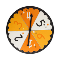 Close-up of spinner featuring numbers 1–6 in Halloween colors