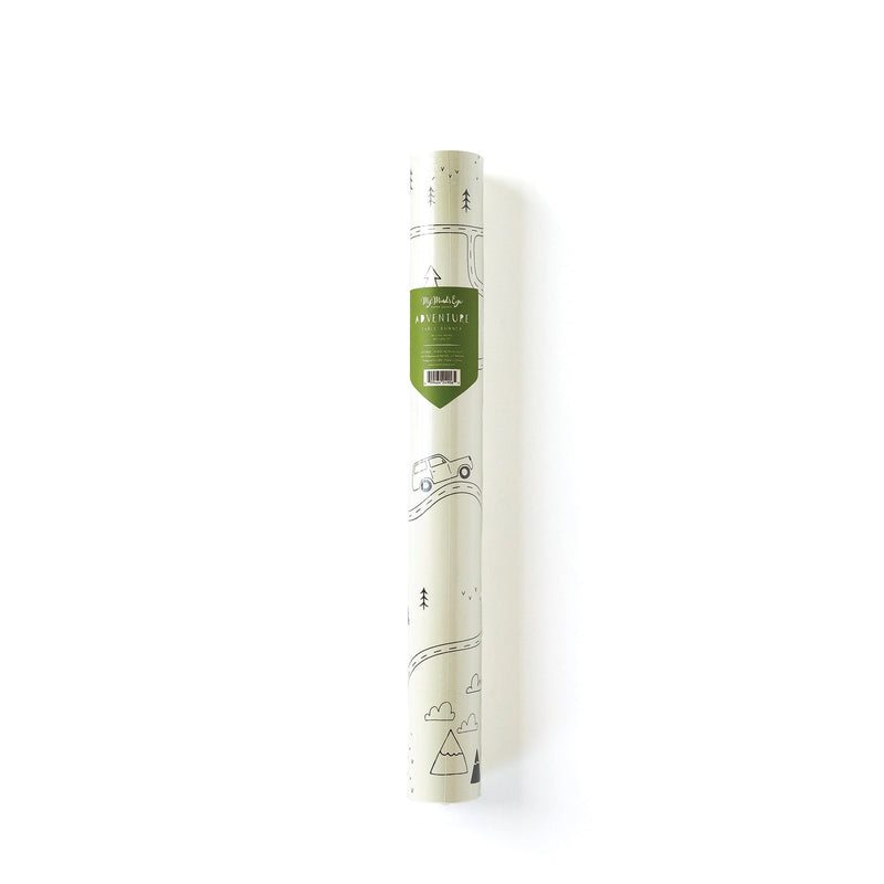 Adventure-themed paper table runner rolled in its packaging, with forest sketch peeking through and a green label showing dimensions and theme.
