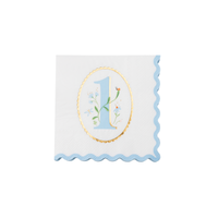 Single white cocktail napkin with sky blue floral illustrated number one ladybug and wildflowers in gold oval scalloped medallion and blue scalloped border on white background