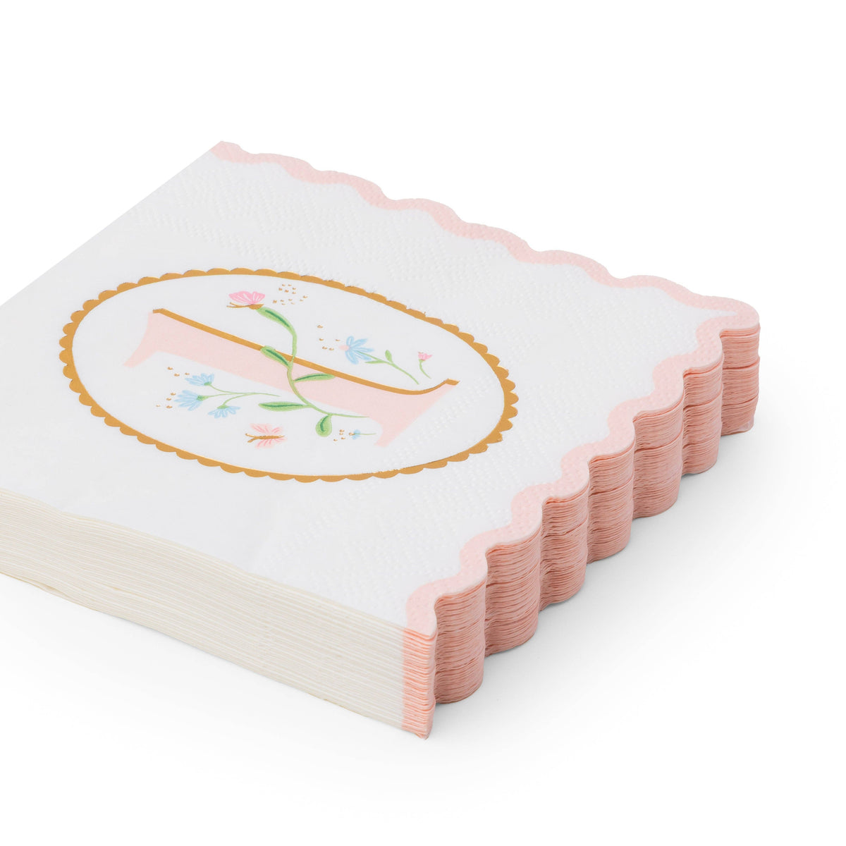 Angled stack of white 1st birthday girl paper napkins with pink floral illustrated number one in gold oval frame and pink scalloped edge on white background