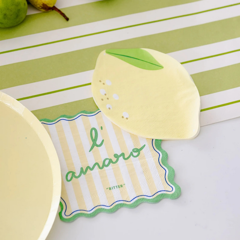 Le Dinner Cocktail Napkin with “l’amaro” text in green stripes alongside lemon-shaped napkin.