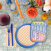 Close-up of Le Dinner Sardine Can Dinner Plate with blue and pink sardine tin illustration.