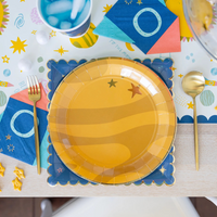 Table setting featuring the Planet Paper Plate with rocket napkins and themed table runner