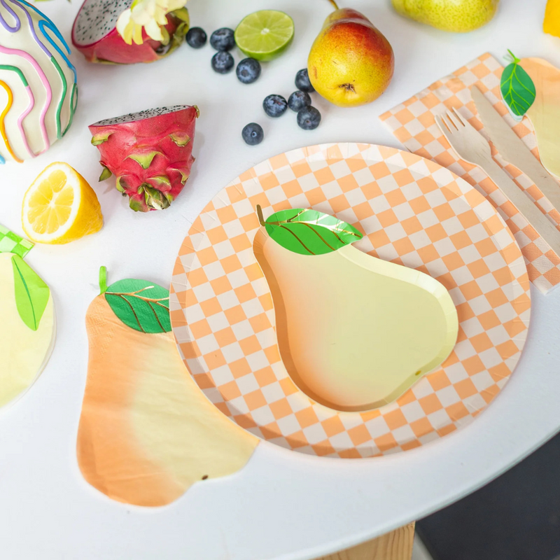 Fruit-themed table setting featuring Le Dinner Pear Large Napkins with vibrant produce and checkered plates