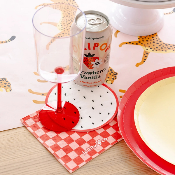 Table setting with drinks and appetizers featuring Le Dinner Dragon Fruit Cocktail Napkins and matching fruit décor