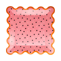 Close-up of a single pink plate with scattered stars and vibrant orange trim