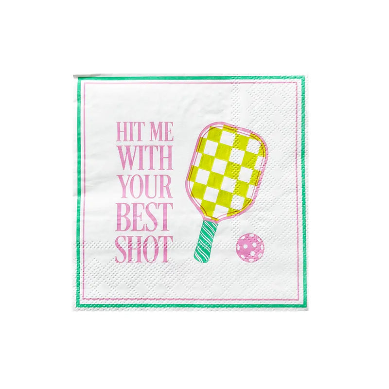 Isolated square cocktail napkin featuring neon checkered paddle and pink ball with ‘Hit Me With Your Best Shot’ text.