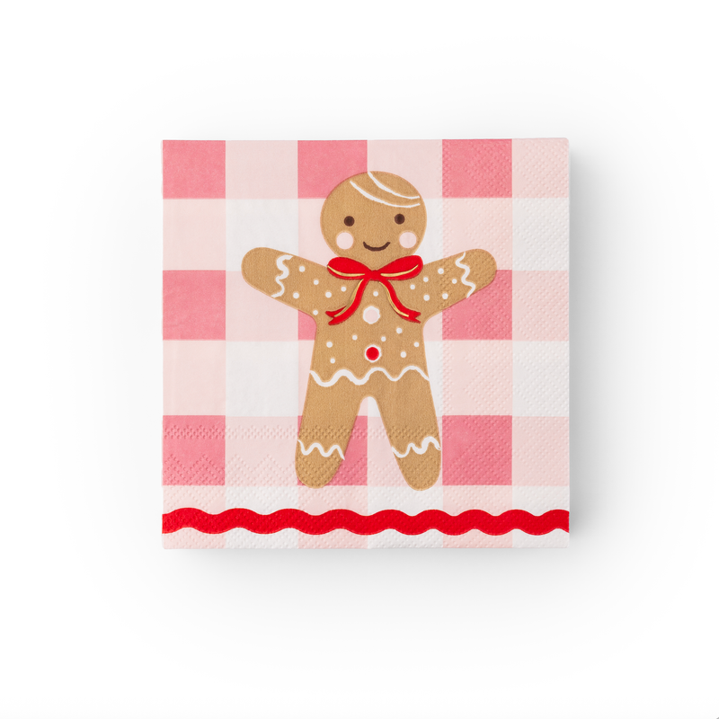 Full view of napkin with smiling gingerbread man, red bow, and scalloped red border.