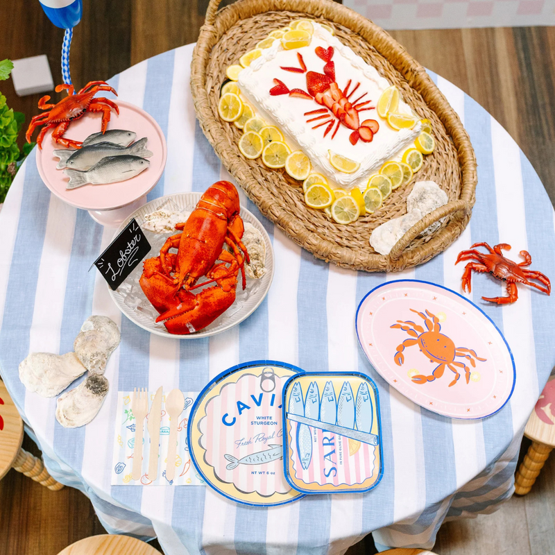 Table set with Le Dinner Sardine Can Dinner Plates featuring sardine tin design and seafood decor.