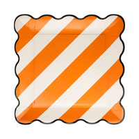 Single orange and white striped 10" plate with black scalloped edge.