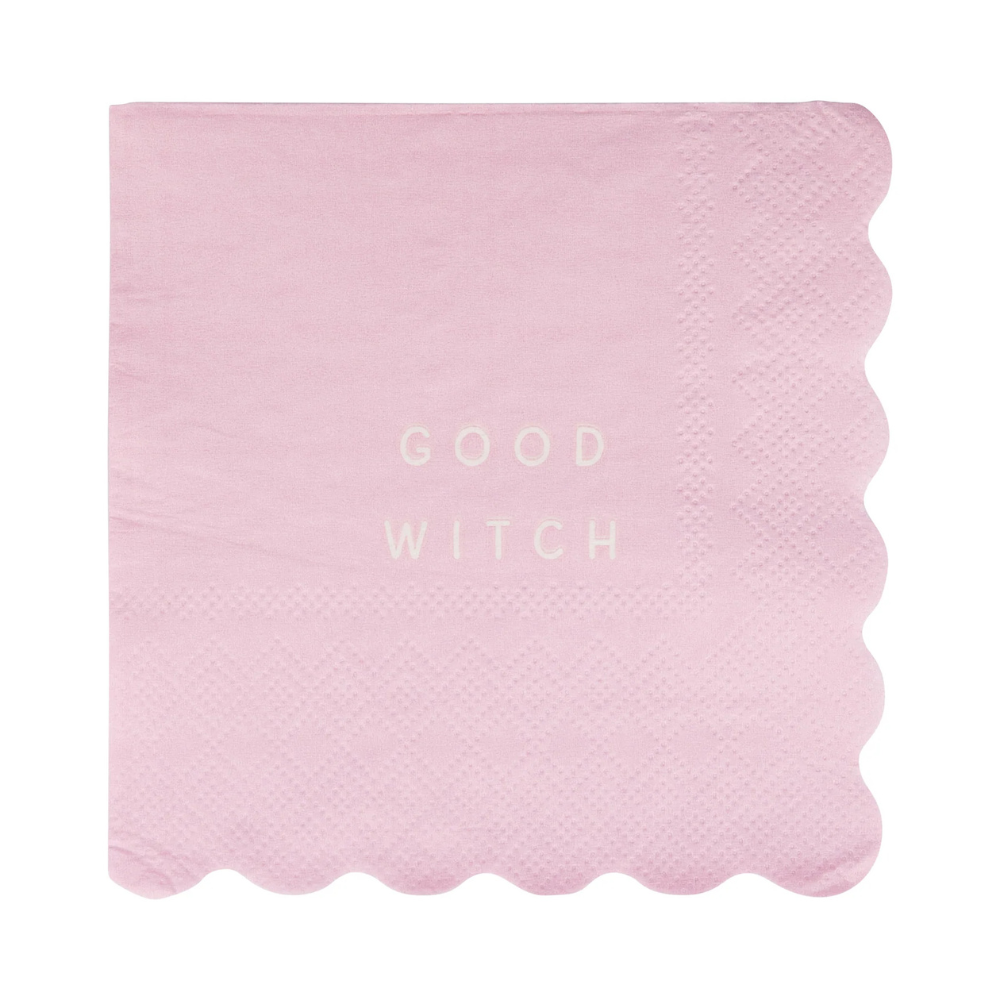 Unwrapped pink napkin with “Good Witch” in white text
