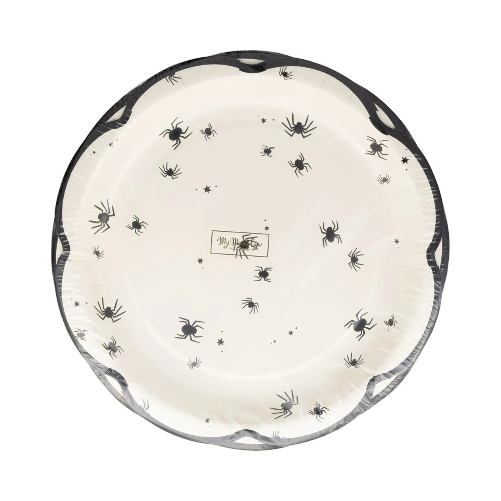 Cream-colored plate with black spiders and stars in a scalloped-edge design.