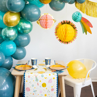 Cups on party table with balloon arch and galaxy-themed decorations