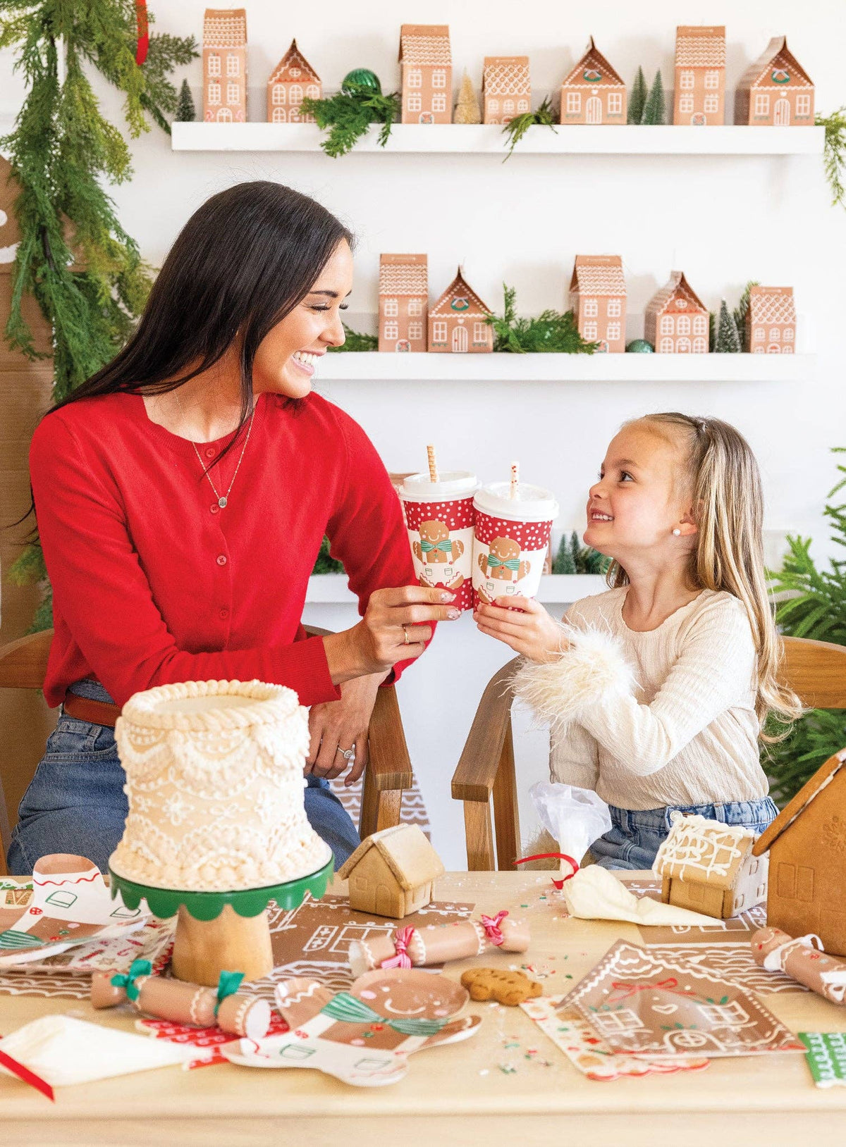 Mom and daughter holding Gingerbread To-Go Cups
Child smiling posing with Gingerbread To-Go Cup with a straw
