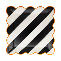Single black and white striped 10" plate with orange scalloped edge.