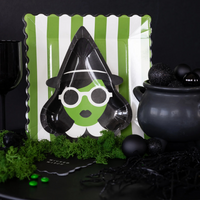 Close-up of green Bad Witch plate on striped background plate