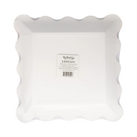 Back of pink paper plate with all-over black star print and orange scalloped edge, in packaging