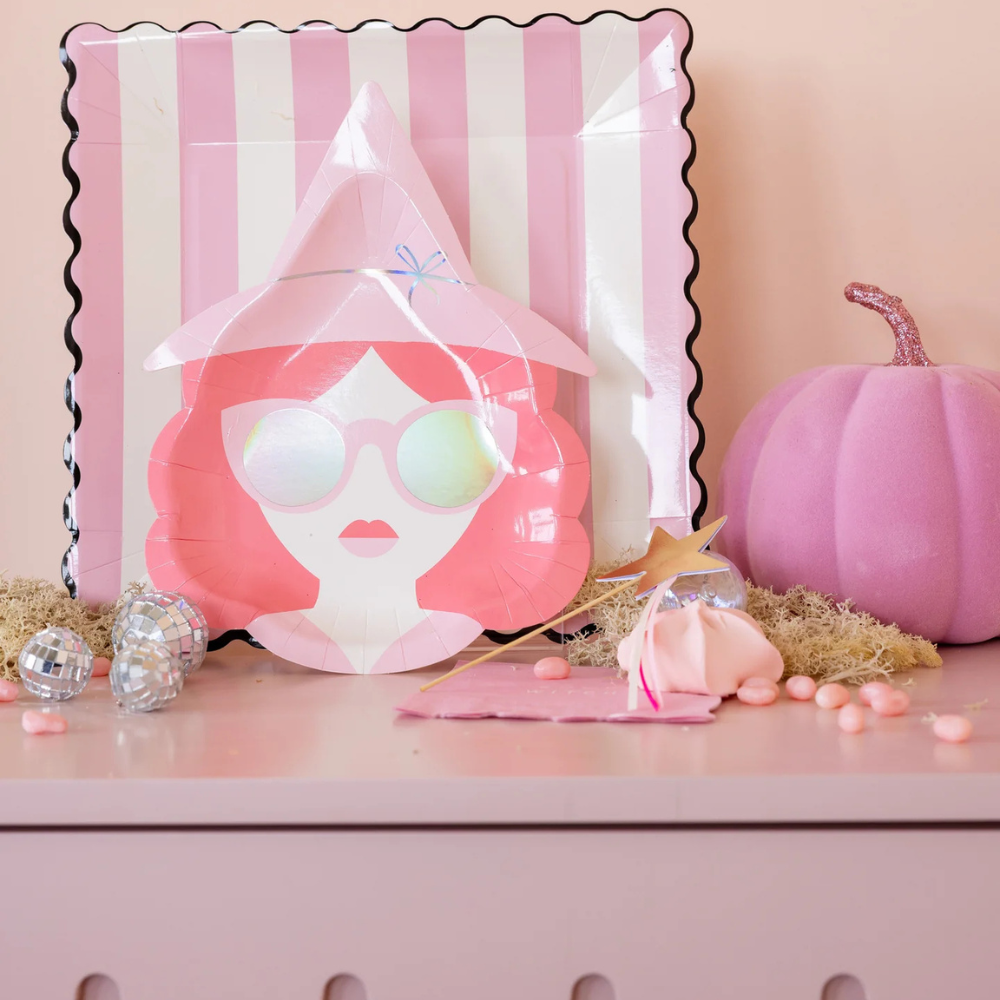 Good Witch plate displayed on a dresser with pink Halloween decor