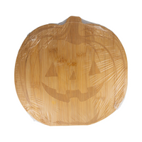 Front of a laser-engraved pumpkin-shaped wood cutting board still in packaging.