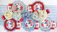 Comprehensive view of a coordinated 4th of July party table with floral paper goods and red party cups.