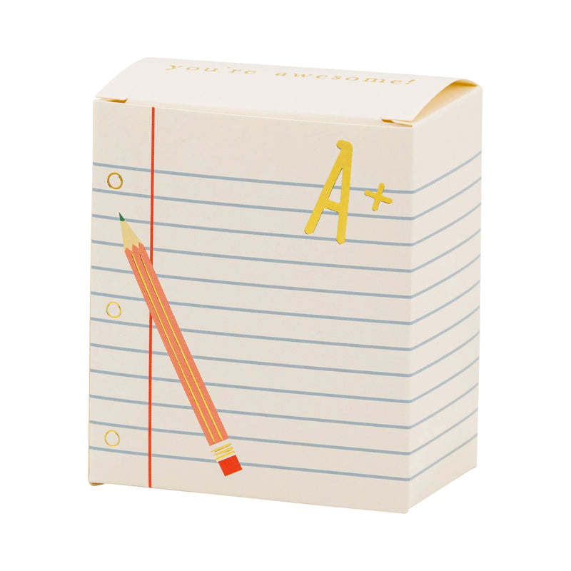  A single assembled treat box with lined paper graphics, pencil, and shiny gold “A+” text.