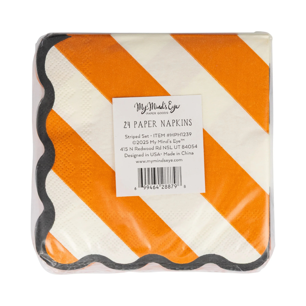 Close-up of packaged orange and white striped paper napkins with black scalloped edges.
