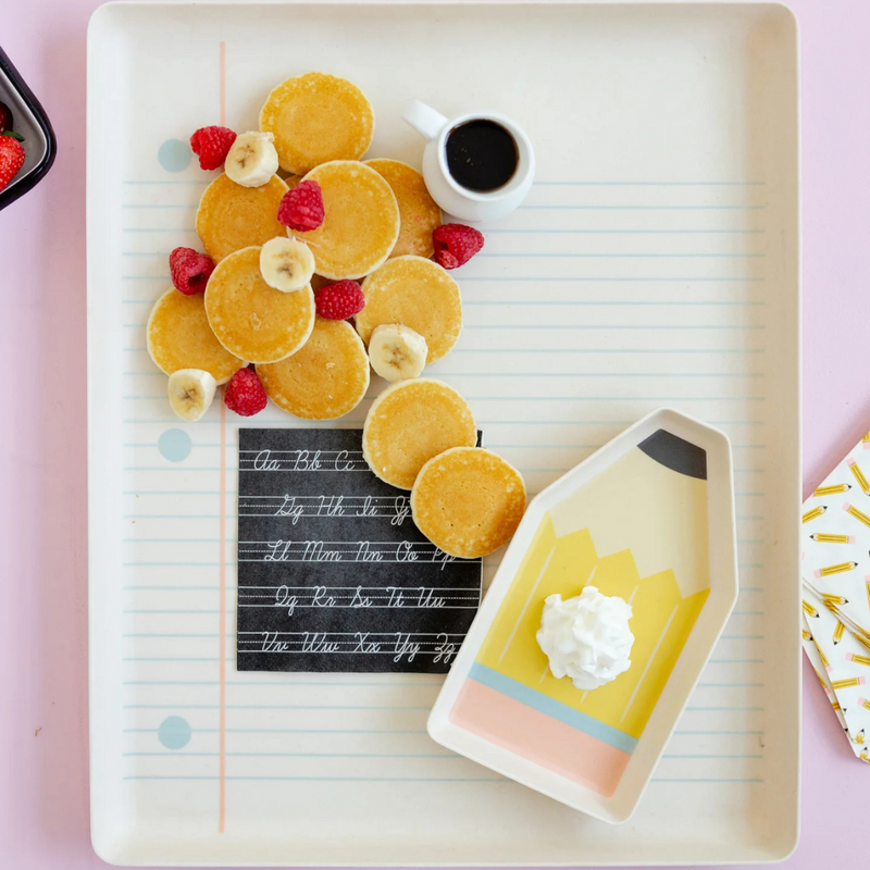 Napkin on tray under mini pancakes with syrup and fruit for a back to school breakfast setup