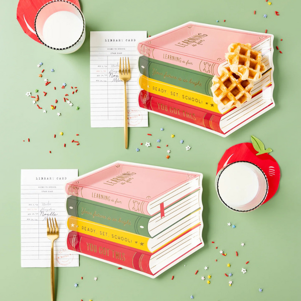 Book-themed plates next to library cards and drinks