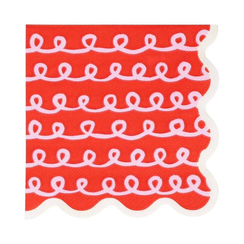 Close-up of red Frosting Cocktail Napkin with white looping frosting pattern and scalloped edge.